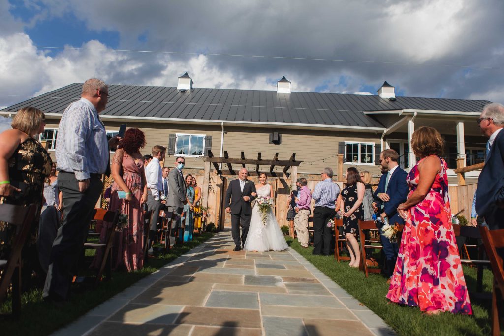 A bride and groom walking down the aisle at a wedding ceremony at Fleetwood Farm Winery.