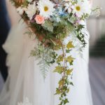 A bride is holding a bouquet of flowers at a wedding ceremony.