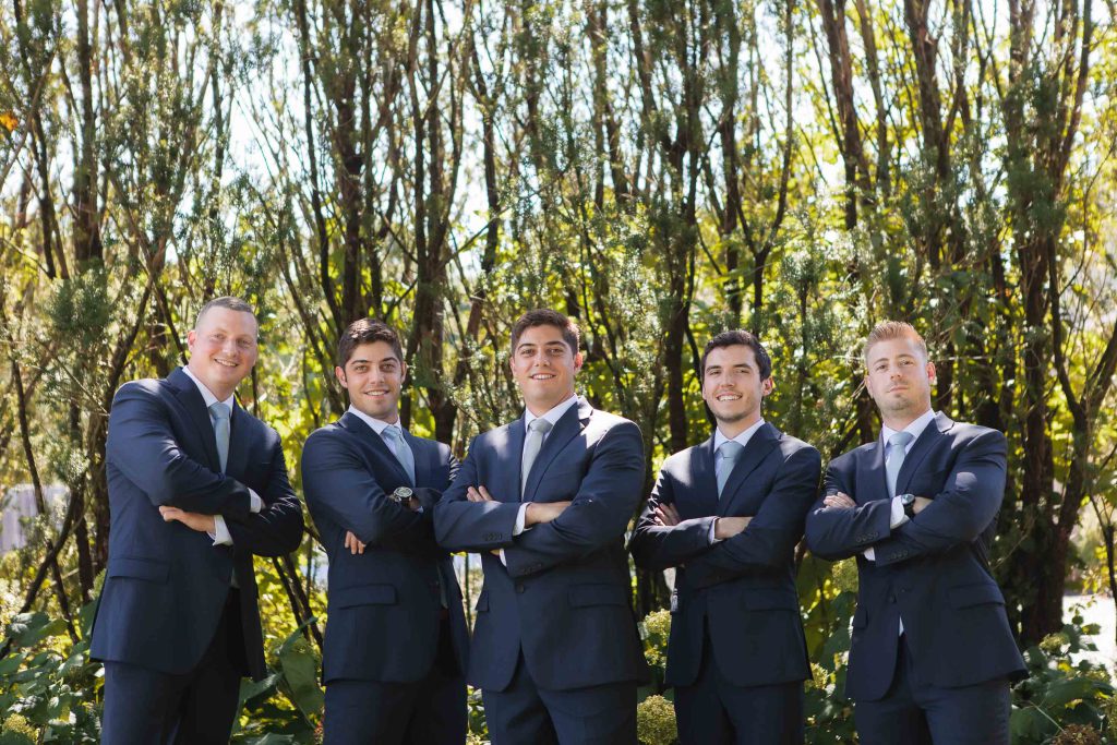 A group of groomsmen posing for a wedding portrait at Fleetwood Farm Winery.