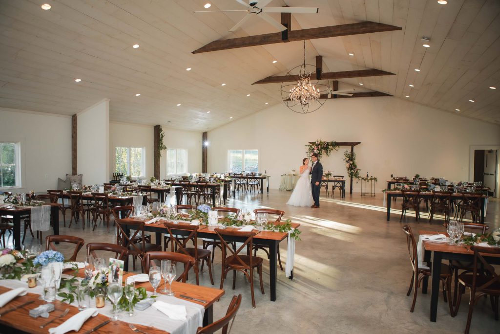 A wedding reception set up at Fleetwood Farm Winery, with tables and chairs.