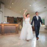 A bride and groom walking through a wedding reception at Fleetwood Farm Winery.