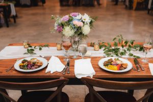A table set with food and wine at a wedding reception by Main Event Catering.