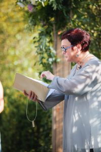 Event vendor holding a book.