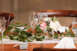 A table setting with flowers and silverware provided by event vendor The Pink Poppy.