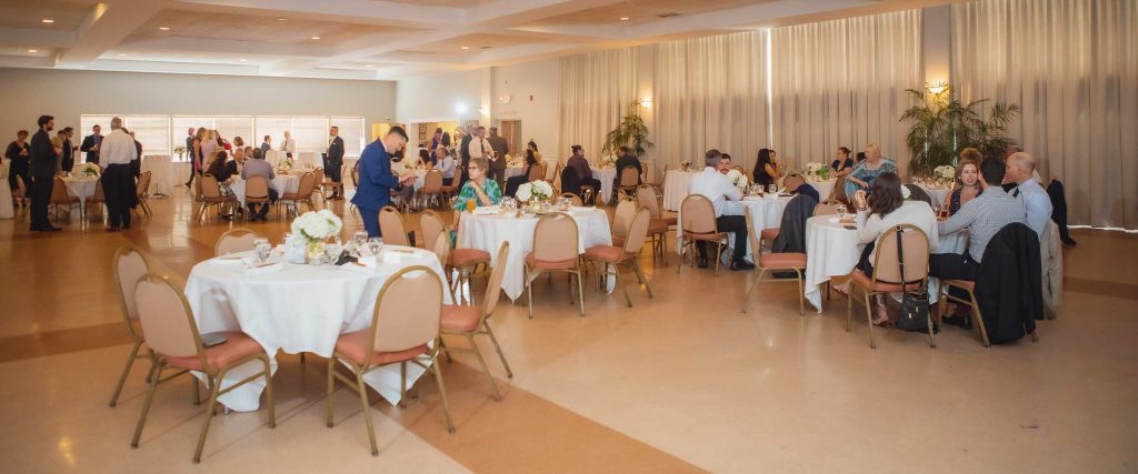 The Knights of Columbus venue is a large room filled with tables and chairs, perfect for any event.