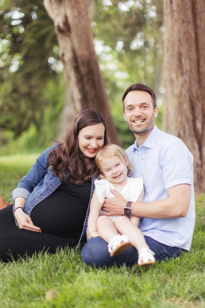 A family posing for a portrait on the grass.
