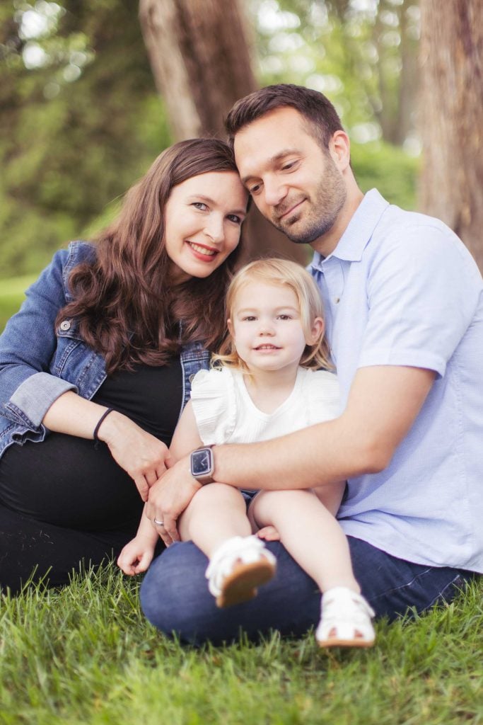 A family sitting on the grass.