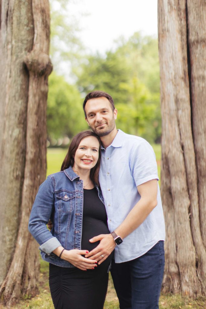 A family posing in front of a tree for their portraits.