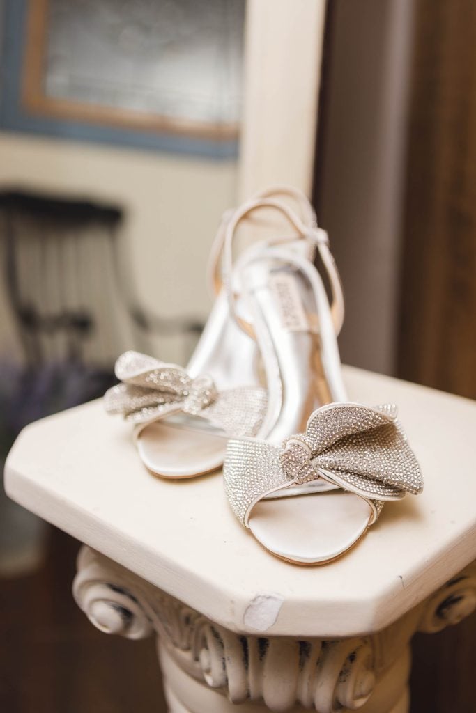 A pair of wedding shoes adding elegant details to a table.