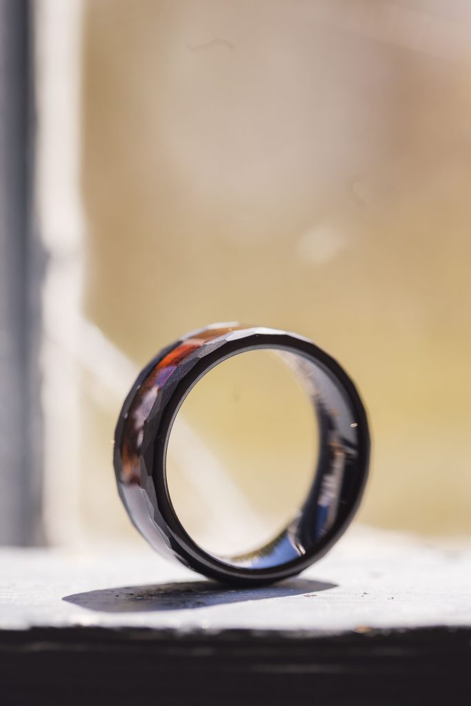 A wedding ring sits on a window sill.