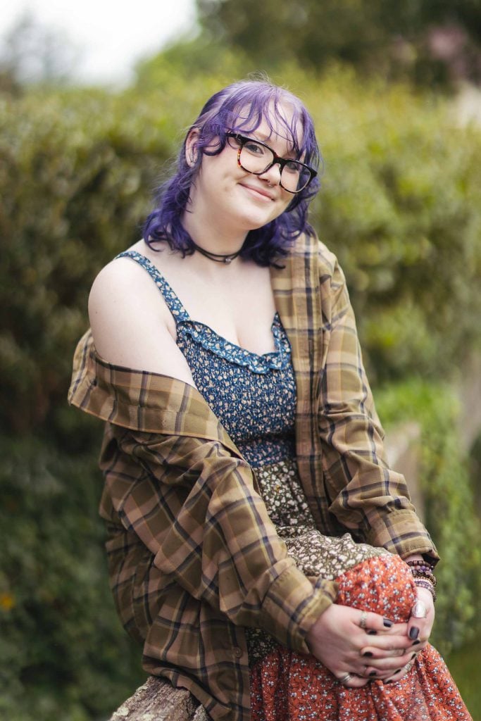 A high school senior wearing glasses and a plaid shirt.