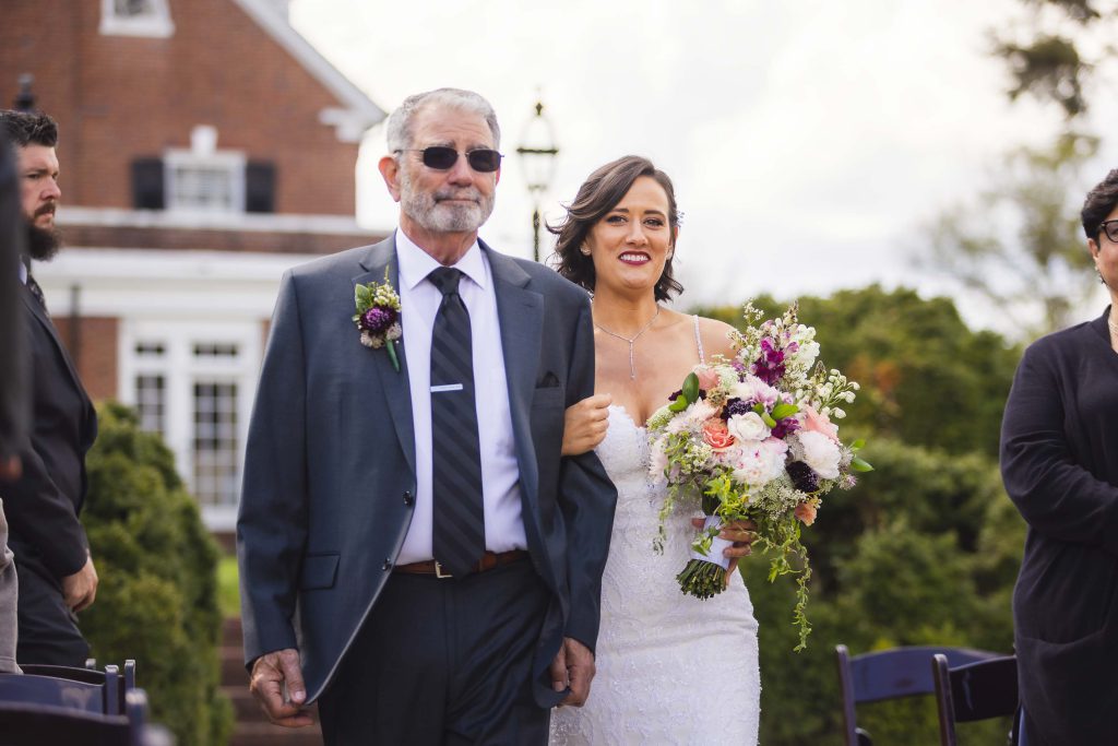 A bride walks down the aisle during her wedding ceremony.