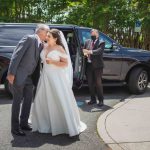 A candid bride and groom kissing during wedding preparation.