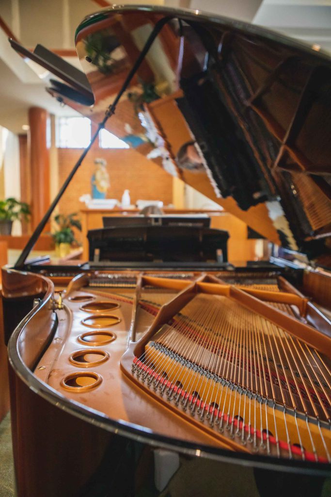 A candid grand piano in a church.