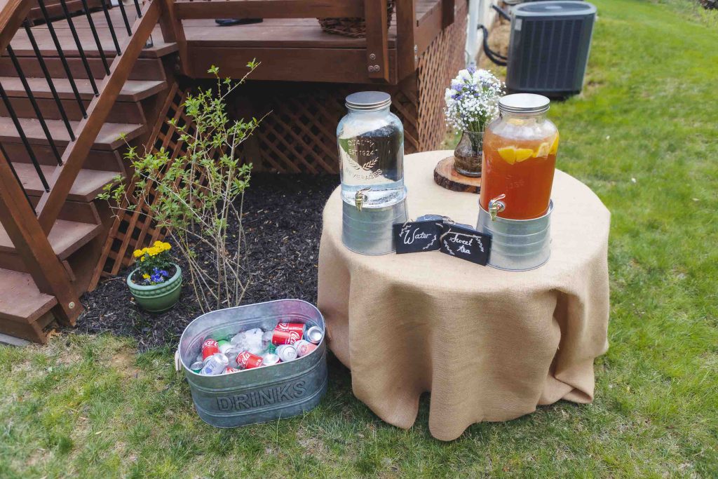 A wedding table with two jars of drinks as decorative details.