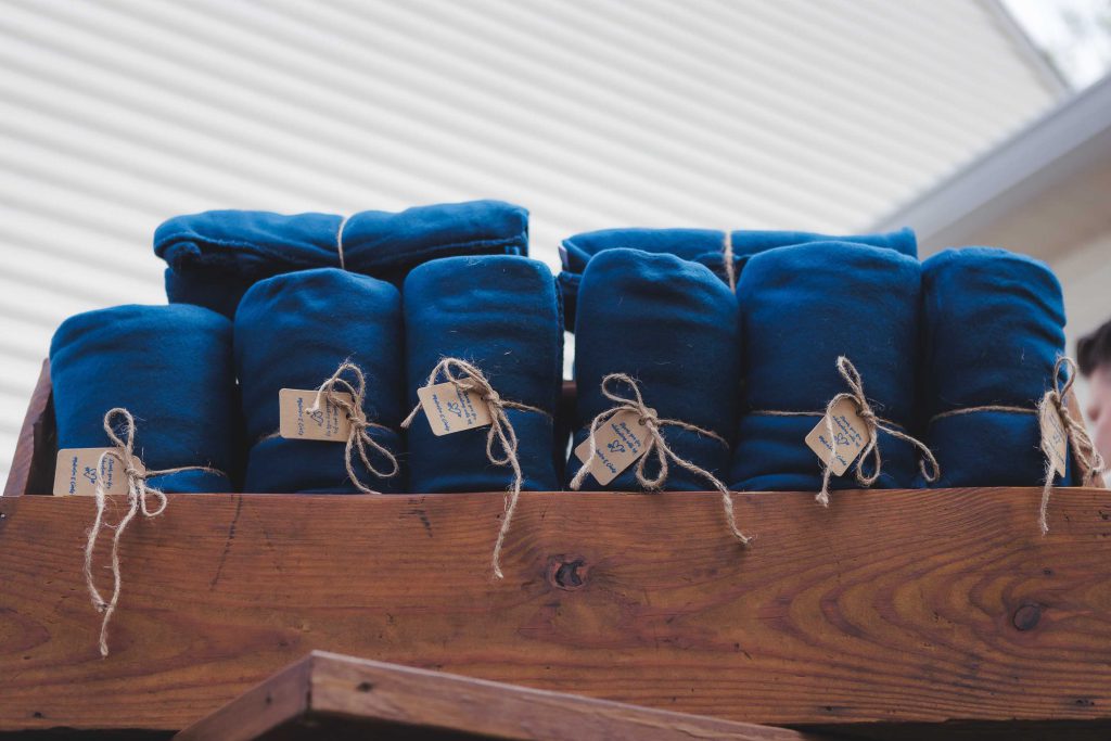 A wooden box filled with blue towels, perfect for wedding decor.