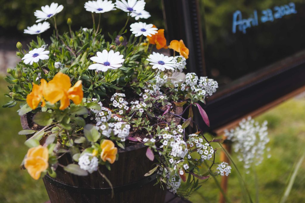 A detailed wedding bucket of flowers.