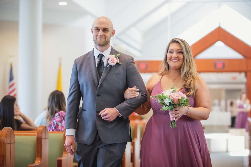 A couple performing a wedding ceremony at a church.