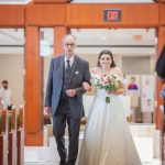 A bride walking down the aisle at her wedding ceremony.