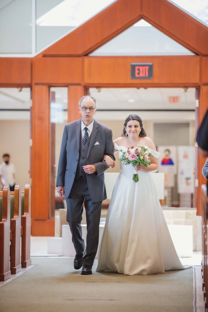 A bride walking down the aisle at her wedding ceremony.