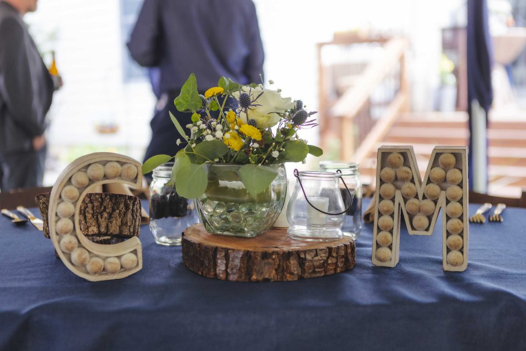 A detailed wedding table with wooden letters and flowers.