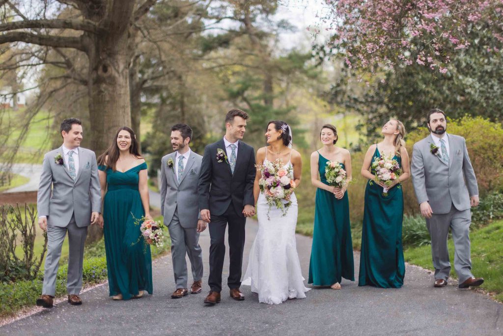 A group of bridesmaids and groomsmen posing for a wedding portrait.