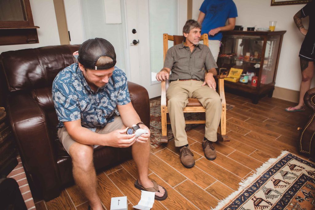 A candid group preparing for a wedding in a living room.