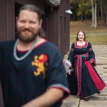 A man and woman dressed in medieval clothing are preparing for their candid wedding.