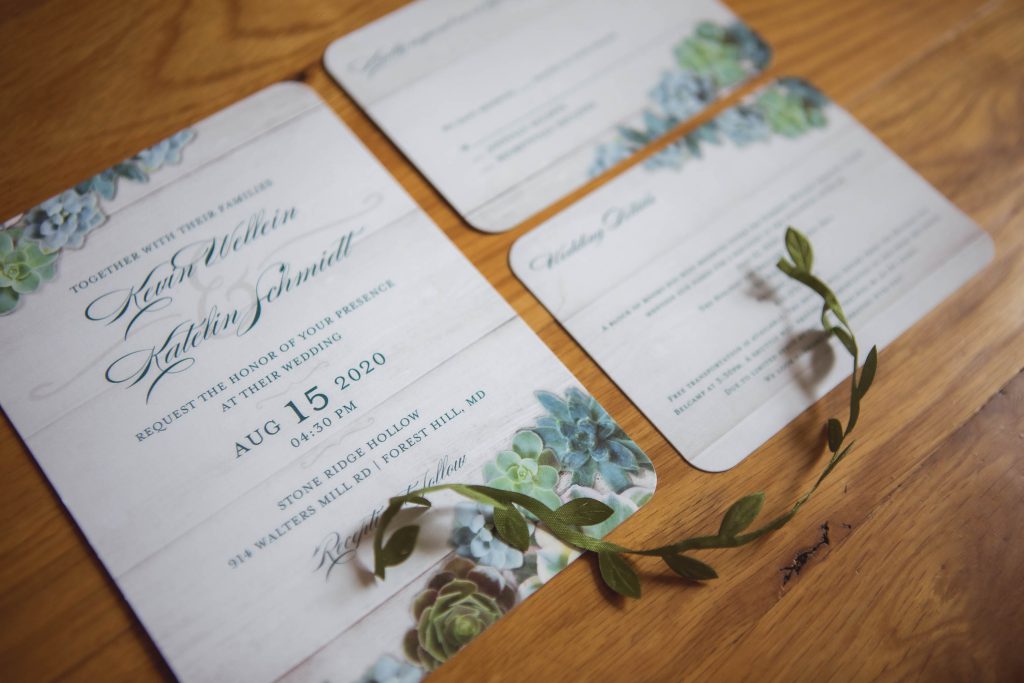 Wedding invitations featuring succulents as part of the decor.