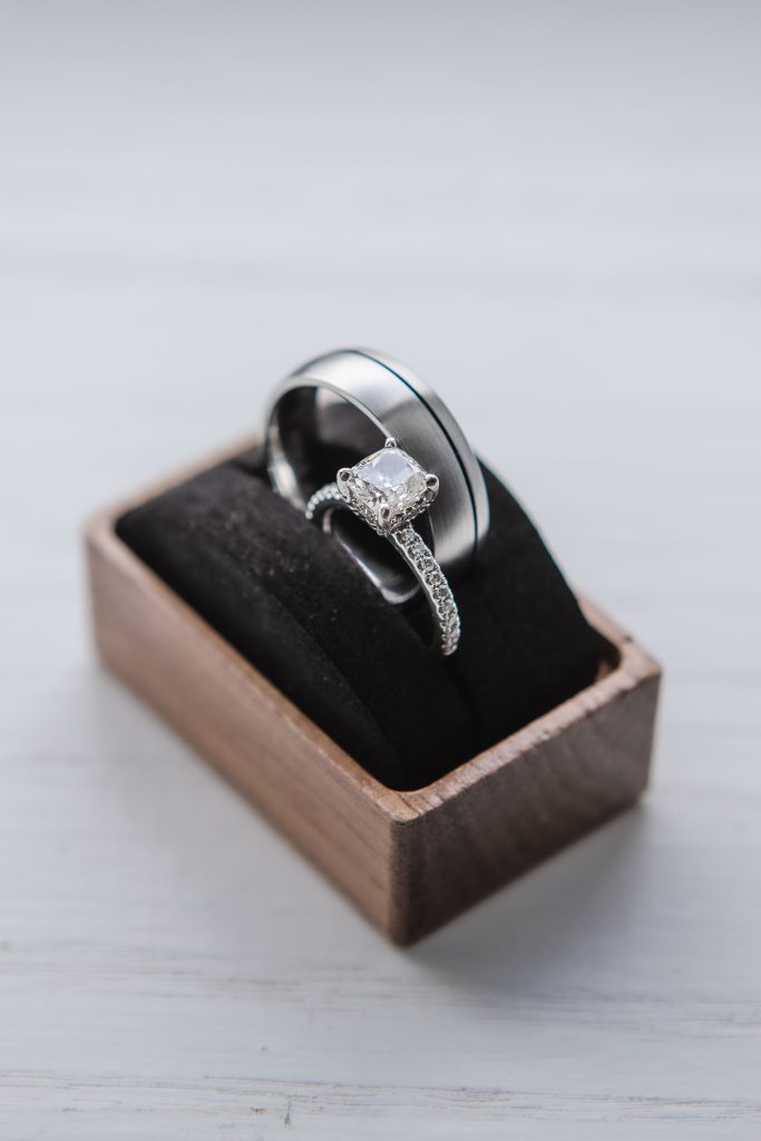 A detailed wedding ring presentation in a wooden box.