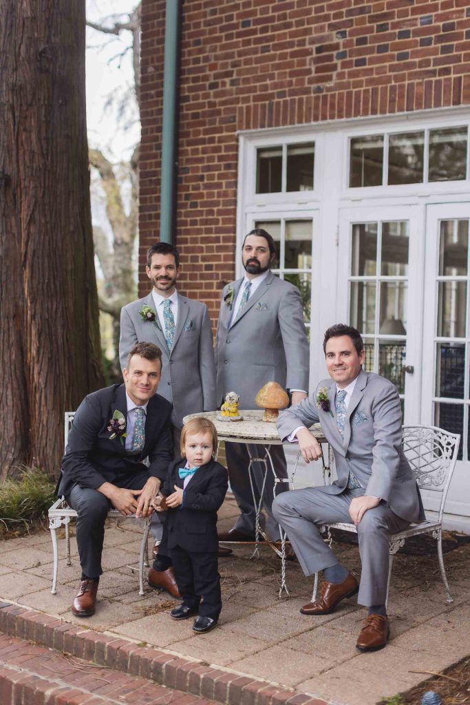 A group of groomsmen posing for a wedding portrait.