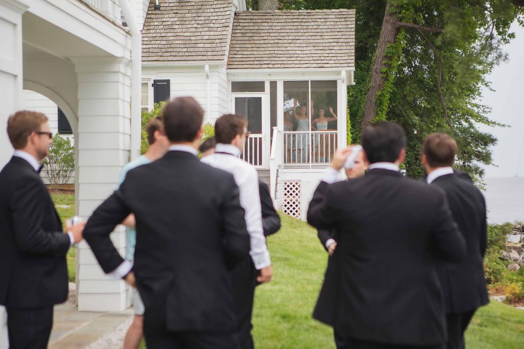 A candid group of groomsmen outside the wedding house.