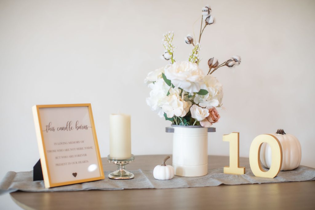 A table with flowers and wedding details.