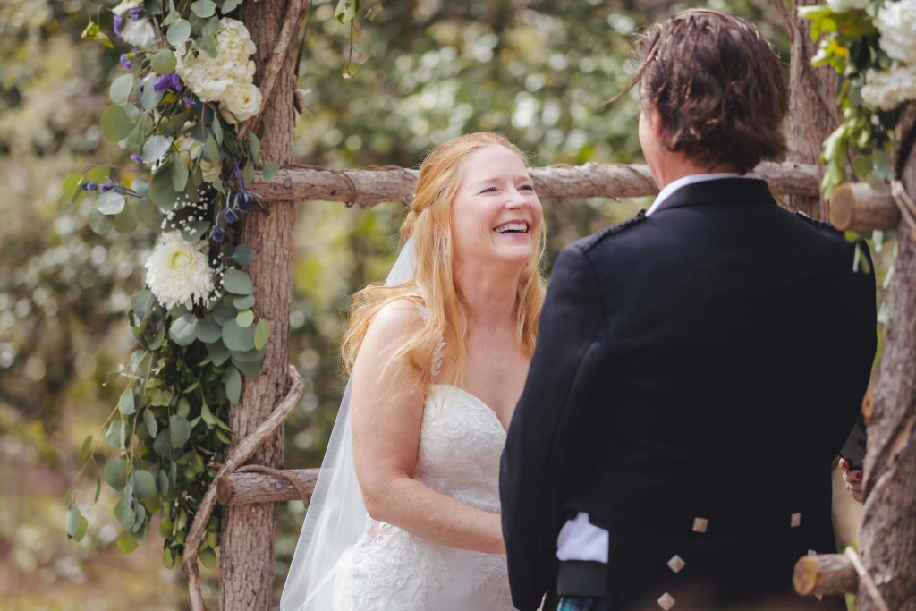 A laughing bride and groom at their wedding ceremony.