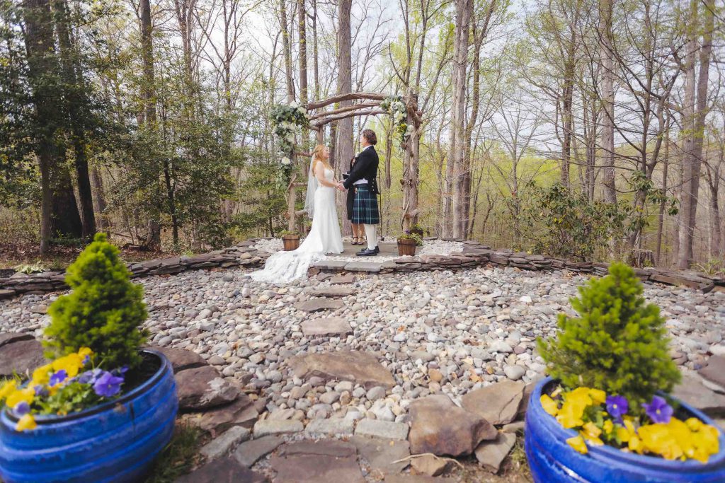 A wedding ceremony in a wooded area.