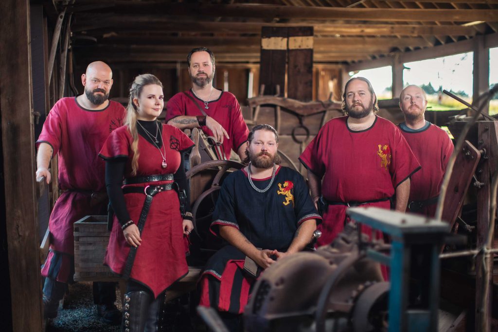 A group of men in medieval costumes posing for a portrait.