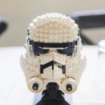 A detailed Lego stormtrooper helmet sits on top of a table.