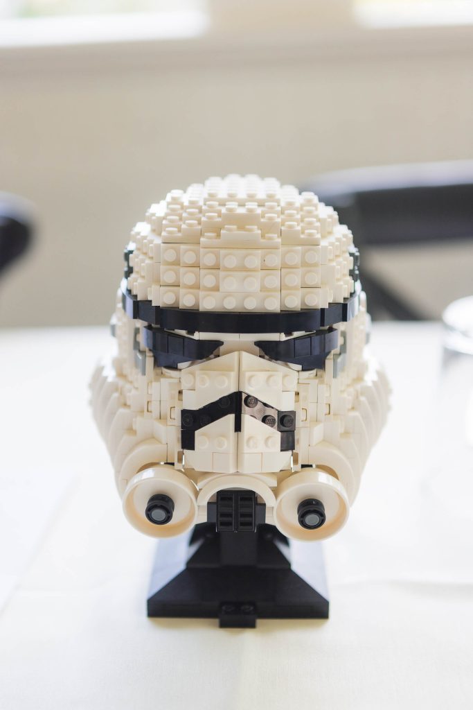 A detailed Lego stormtrooper helmet sits on top of a table.