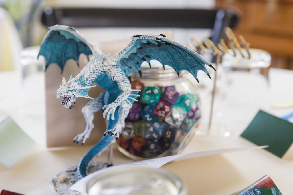 A blue dragon figurine adds wedding details to the table décor.