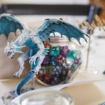 A blue dragon figurine adds wedding details to the table décor.