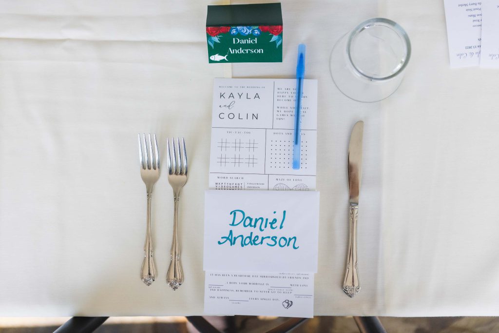 A detailed wedding table setting with a knife, fork, and spoon.