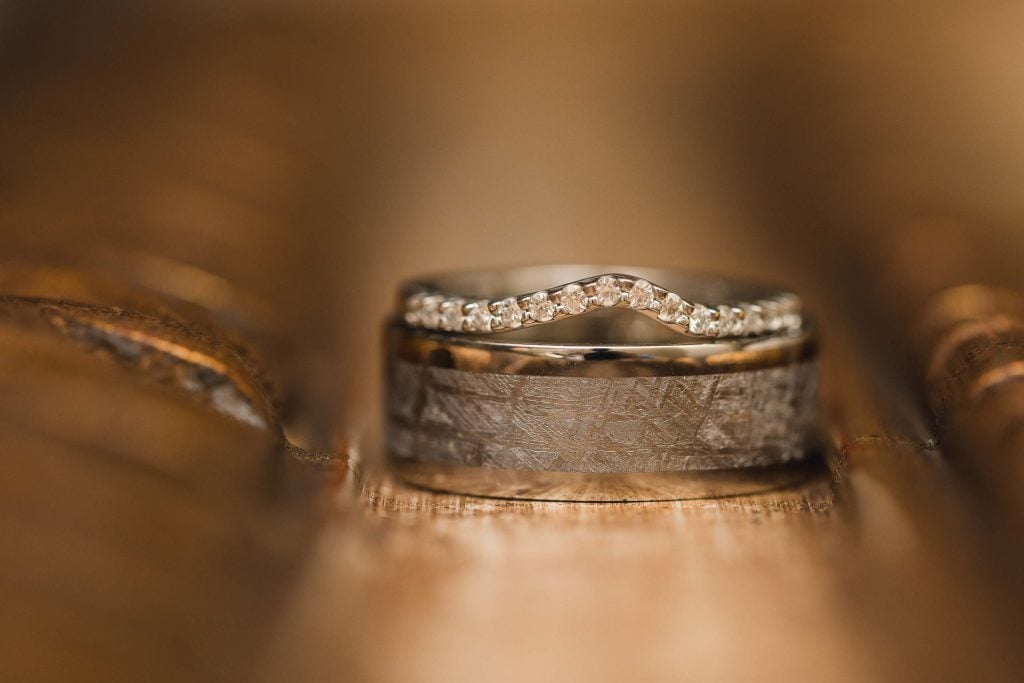 A detailed wedding ring atop a book.