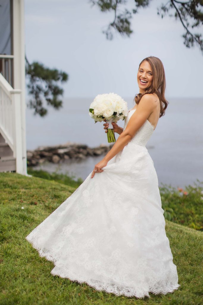 A bride in a white wedding dress posing for a portrait.