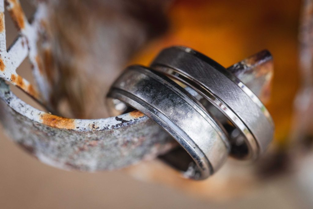 Two detailed wedding rings on a piece of metal.