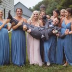 A group of bridesmaids and groomsmen posing for a wedding portrait.