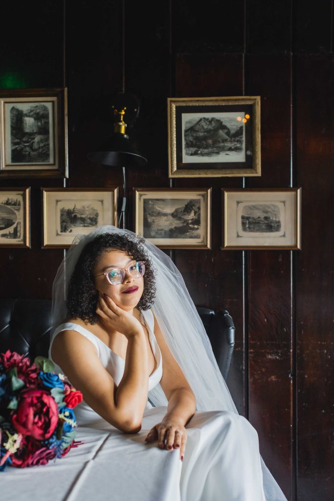 A bride posing with her bouquet at a wedding portrait session.