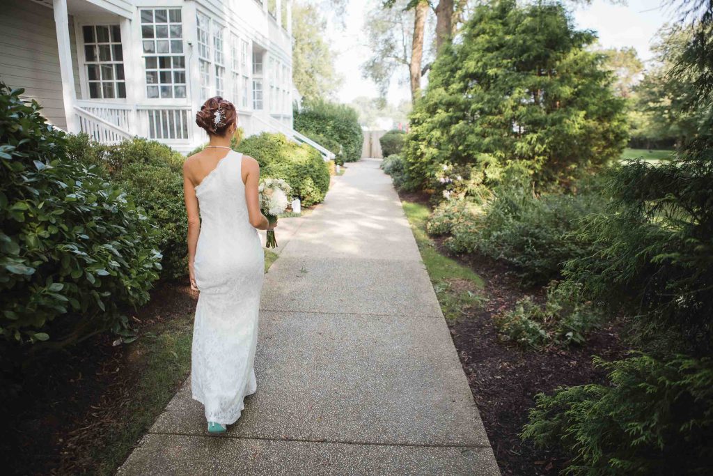A candid bride preparing for her wedding at a house.