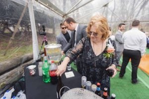 A woman pouring a drink at a wedding reception.