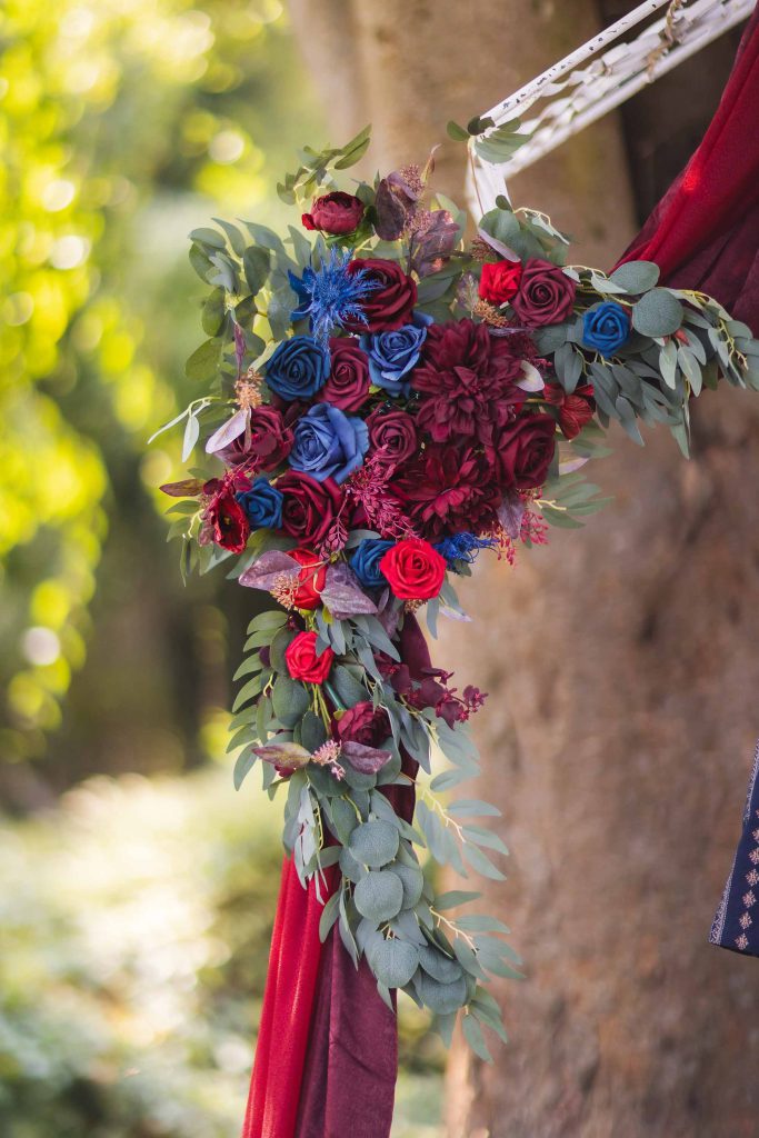 A wedding arch adorned with vibrant flowers.
