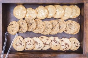 Keywords: Details
Modified Description: An intricately arranged tray of cookies on a rustic wooden table.